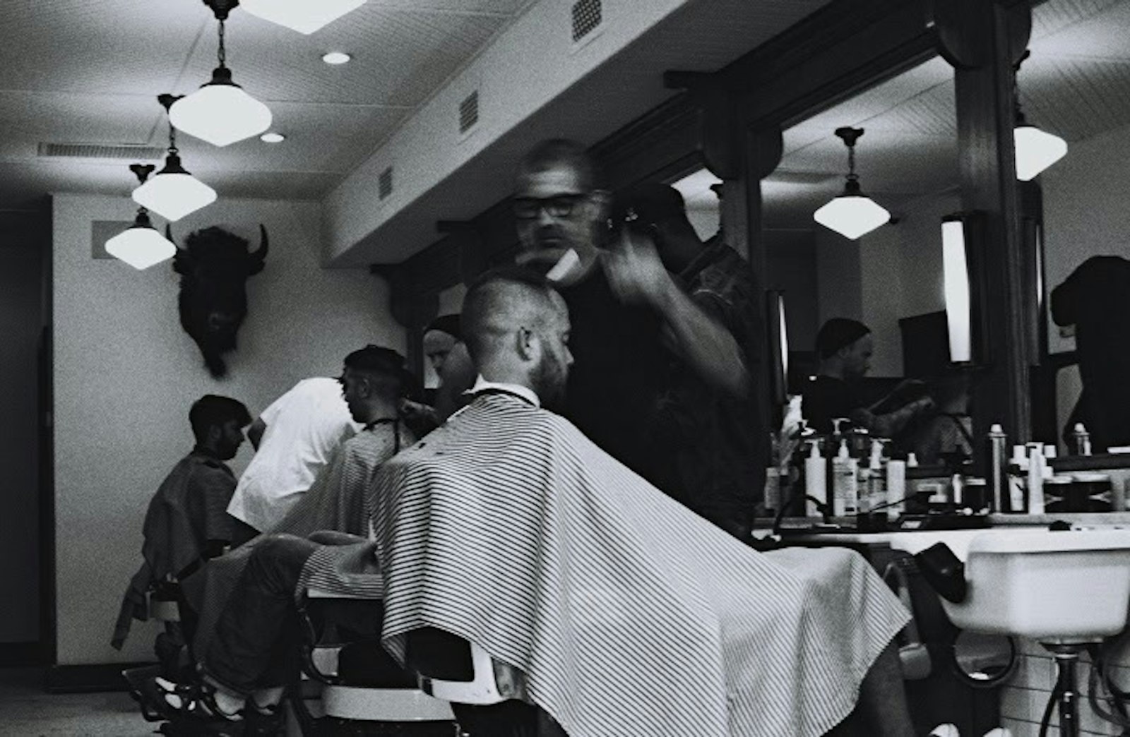 Barber at work in a classic barbershop, black and white